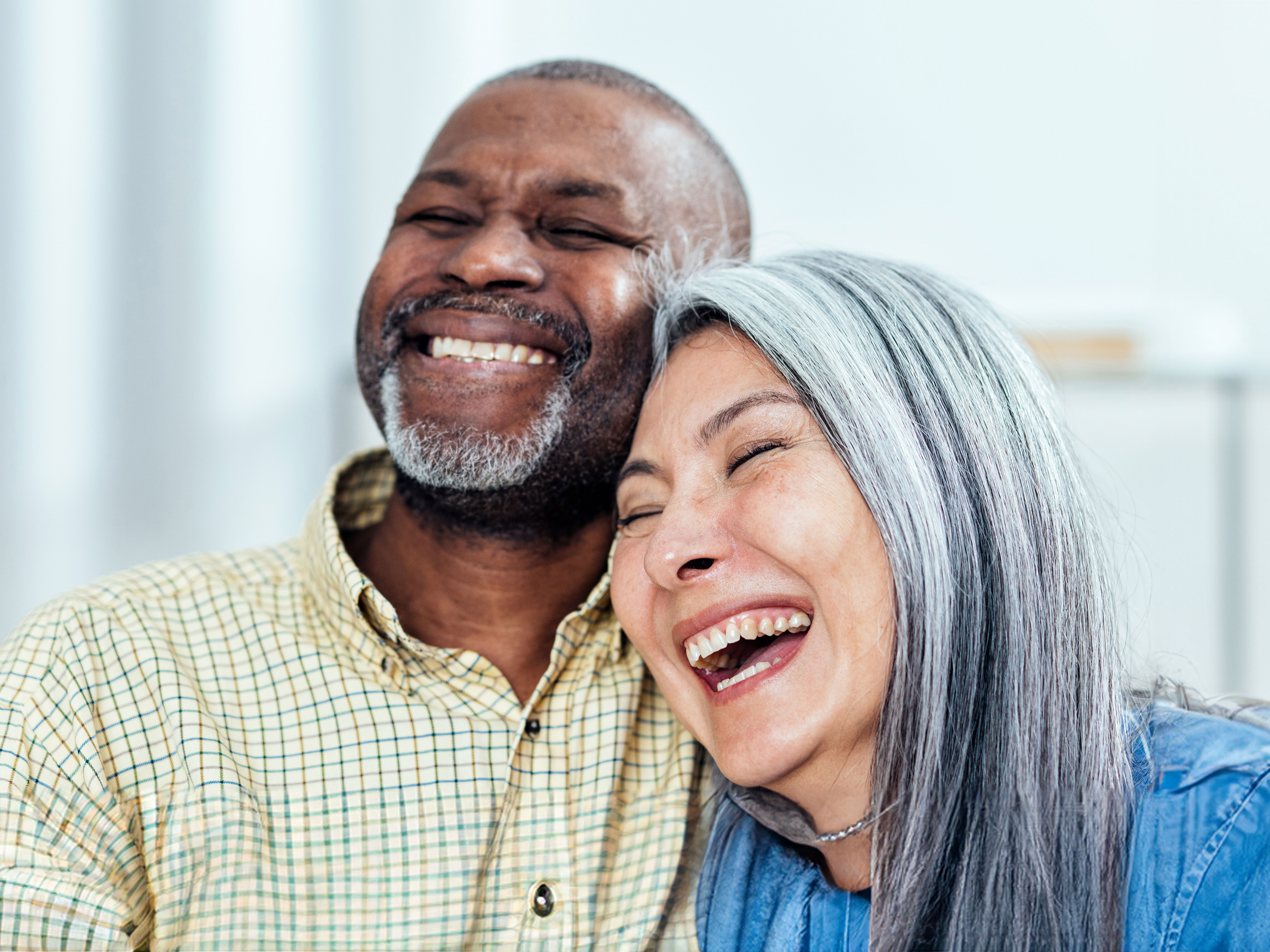 Image of a woman and man hugging and laughing